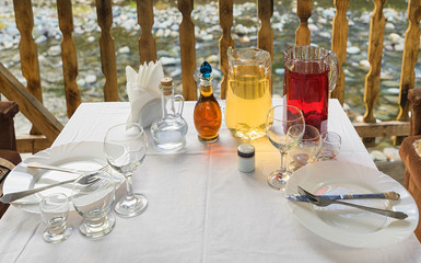 Different bottles and decanters of wine and spirits on the table. Decanters with vodka and home made cognac.
