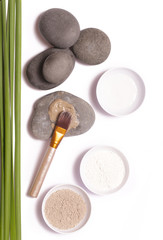 Cosmetic clay beside zen stones, natural cosmetics products concept