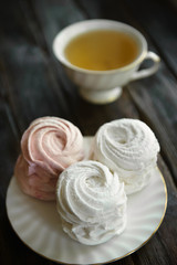Homemade vanilla meringue dessert on a plate with tea