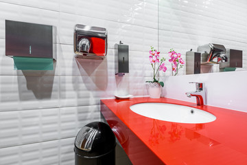 Red countertop in public restroom