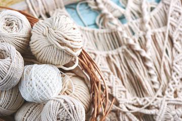 Handmade macrame braiding, background thread on a wooden Board top view