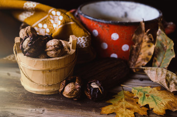 Walnuts on rustic table with old details on it. Autumn style.