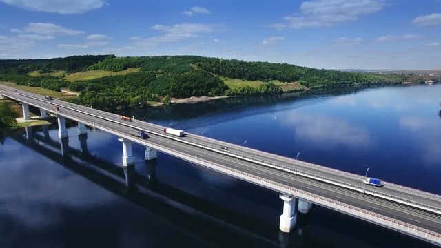 AERIAL Fly over traffic bridge highway roadway road way and blue river with trees forest, Europe, Russia, Tatarstan