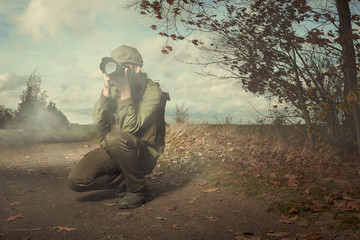 Photographer in war conflict field zone shooting photos