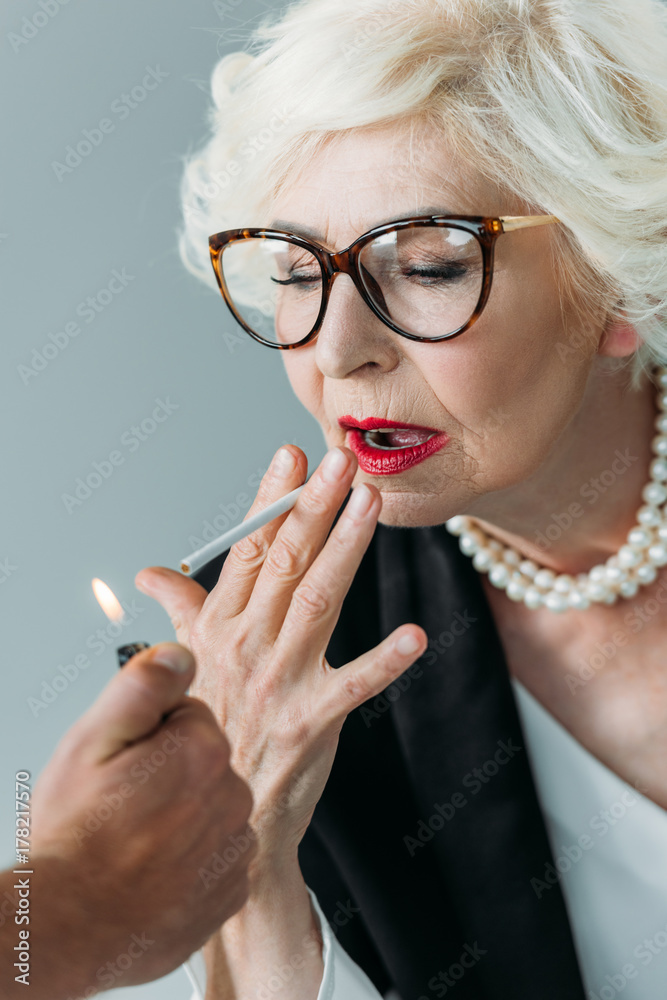 Wall mural senior lady smoking cigarette