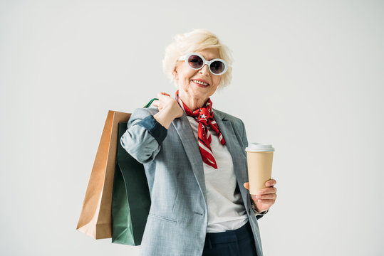 senior woman with shopping bags and coffee