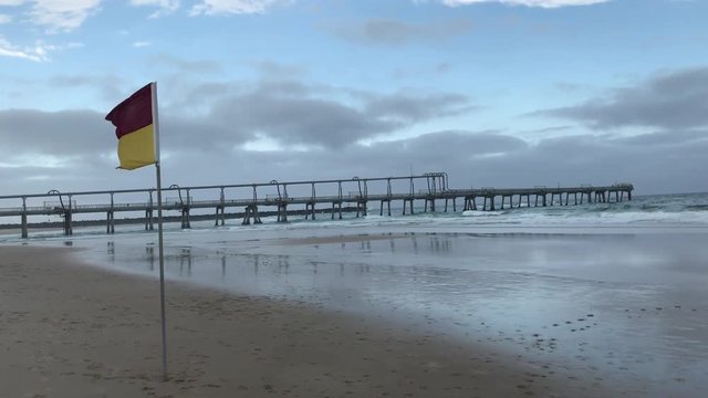 stormy australian beach and flag