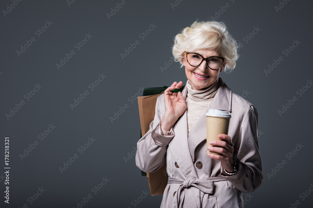 Wall mural senior woman with shopping bags and coffee