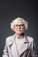 senior lady in trench coat
