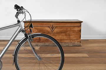 Interior with vintage wooden chest and Bike in foreground - Powered by Adobe