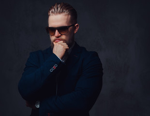 Fototapeta premium A man dressed in a suit and sunglasses.