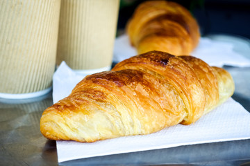 Breakfast with coffee and croissants on table