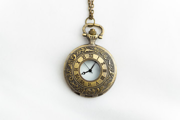 closed pocket watch on white background old