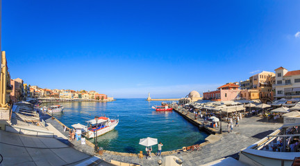 Fototapeta na wymiar GREECE, CRETE, CHANIA - October 18, 2017: Old city, Venetian harbor, view of the embankment, pier and Egyptian lighthouse, editorial.