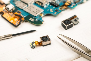Disassembled cell phones and other gadgets in repair shop