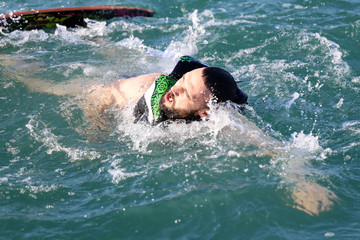 A man is swimming in the sea