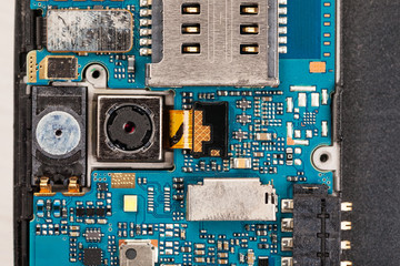 Disassembled cell phones and other gadgets in repair shop