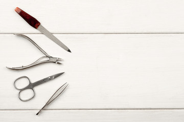 Nail care items on a white table top view, copy space