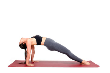 young asian woman doing yoga in Purvottanasana or Upward Plank yoga pose on the mat isolated on white background, exercise fitness, sport training, healthy lifestyle concept