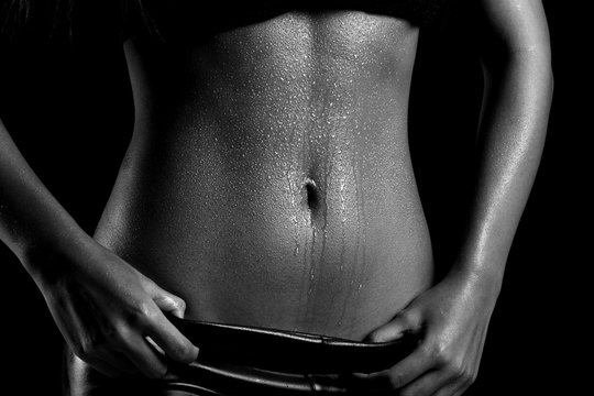 Fitness Model Lady woman sweaty sporty belly after heavy exercise, weight loss black and white concept