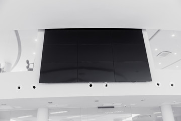 multiple screen LCD panel display in modern building office wall with clipping path at screen