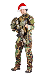 soldier with rifle wearing Santa claus cup and holding cardbox isolated on white background