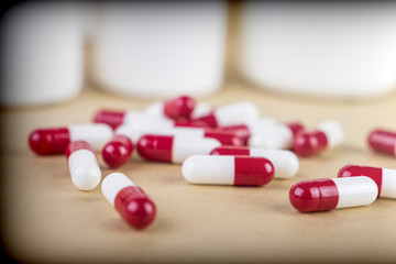 Some white and red capsules along with closed boat, conceptual image