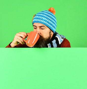 Autumn and hot drink season concept. Hipster with beard