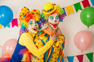 Two cheerful clowns. Birthday for children. Bright clown and clowness.