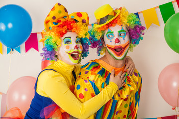 Two cheerful clowns. Birthday for children. Bright clown and clowness.