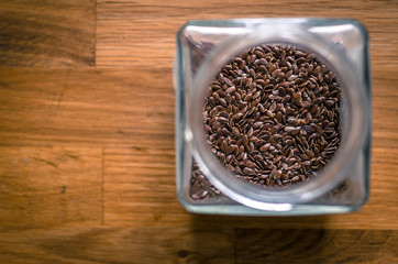 Top View on Glass jar with  dried herbs on the old wooden table