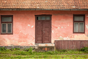 Wall with door and two windows.