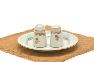 Salt and pepper containers on white background