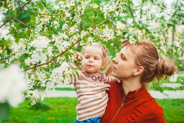 mother and daughter in flower garden