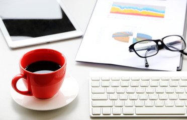 Red Coffee Cup on the desk Business Workspace background in Office Morning work