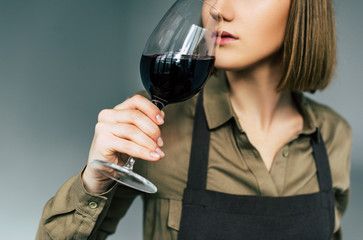 sommelier examining red wine