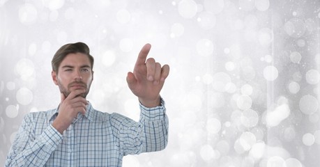 Businessman touching air in front of sparkles