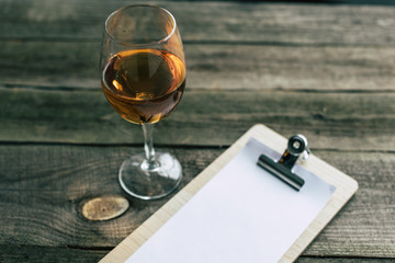 glass of white wine and clipboard