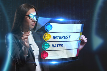 The concept of business, technology, the Internet and the network. A young entrepreneur working on a virtual screen of the future and sees the inscription: Interest rates