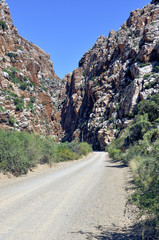 Fototapeta na wymiar Dirt Road Leading to Between Rocky Hills