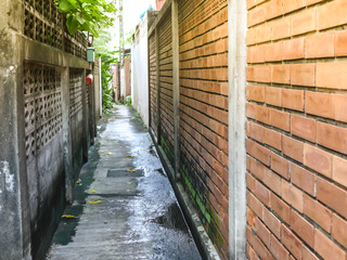 Fototapeta na wymiar The narrow corridor between the two walls