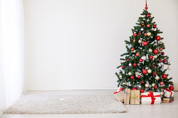 Christmas tree with red gifts in the white room Christmas