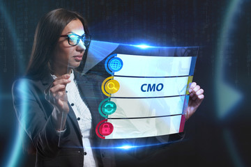 The concept of business, technology, the Internet and the network. A young entrepreneur working on a virtual screen of the future and sees the inscription: CMO