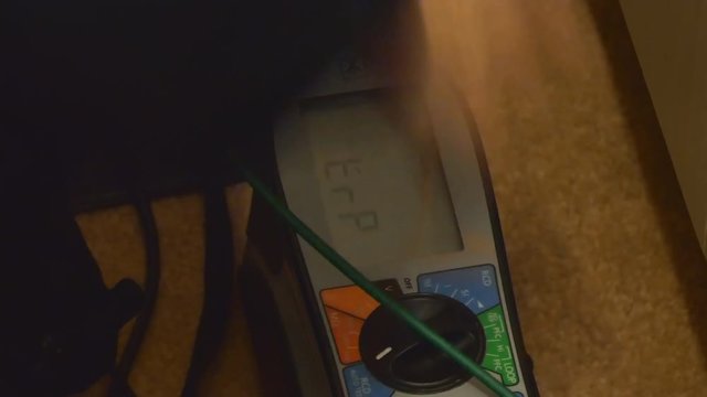 Close up of professional RCD, residual current device tester or meter which is being used by electrician testing residential house electrical wiring for safety and faults.