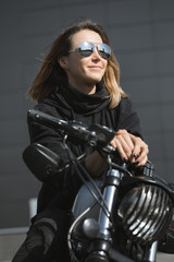 Naklejka na ściany i meble biker woman sitting on motorcycle