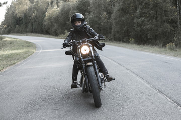 Fototapeta na wymiar Young woman driving motorcycle
