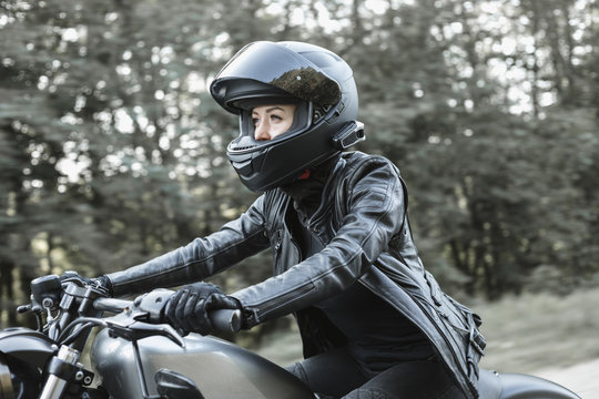 Young woman driving motorcycle