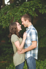 Loving couple embrace each other in orchard