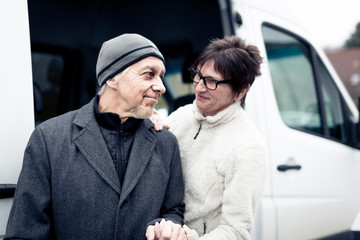 Nurse Helping Senior Man Enter A Van