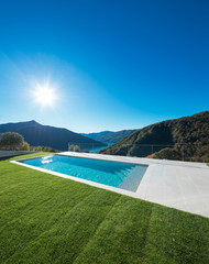 Modern swimming pool with lake and valley view